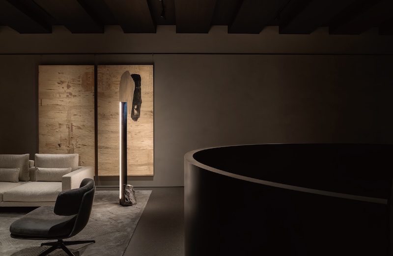 A floor lamp lighting a quiet corner after dark