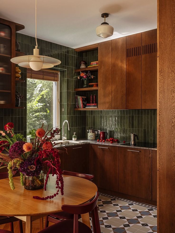 A kitchen in green tile and dark timber
