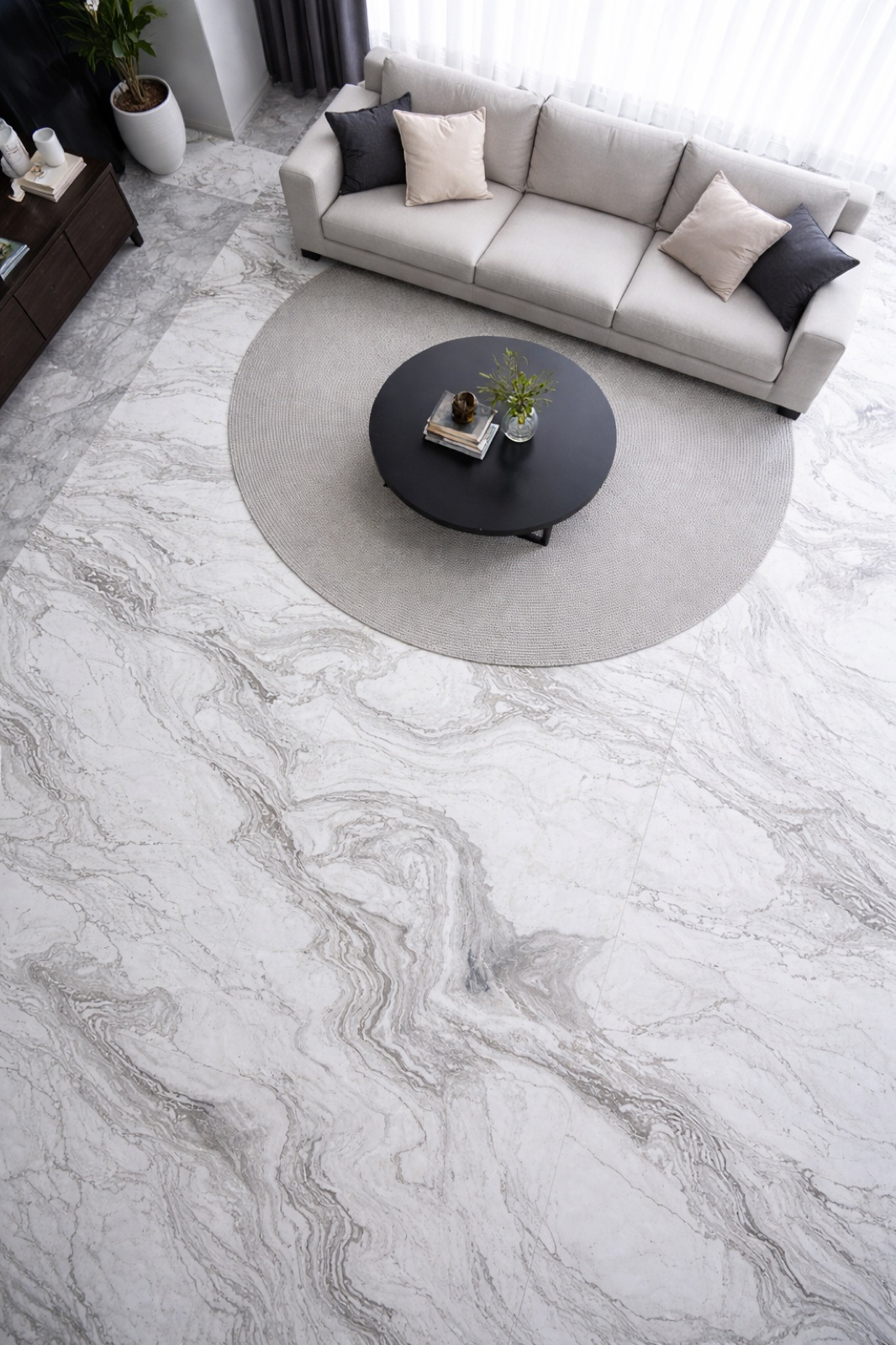 A grey and white veined marble floor across a living room
